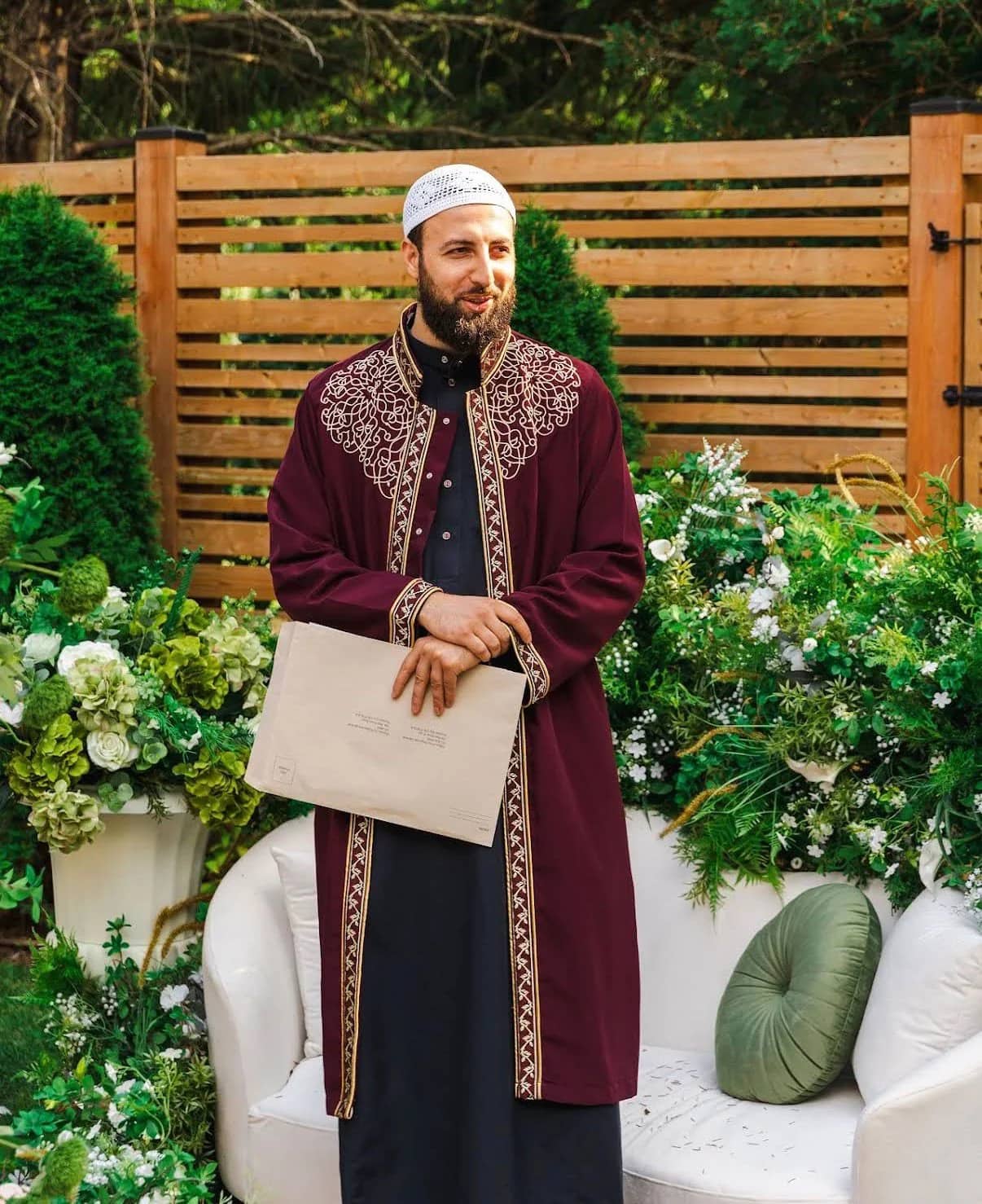 Imam Zaniar Ahmad holding Ontario marriage documents at an outdoor Nikah ceremony